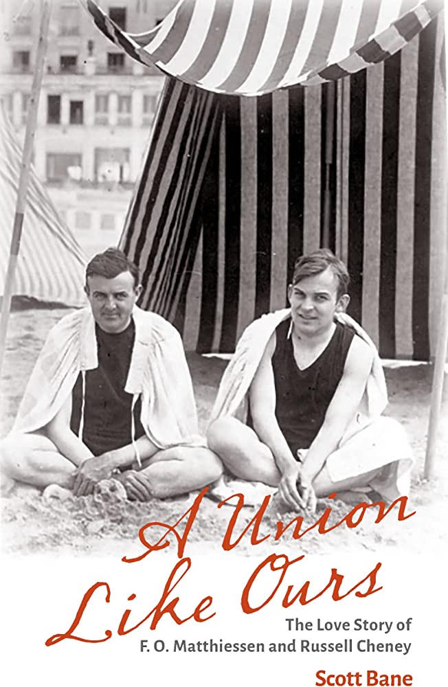 Cover of A Union Like Ours, featuring two men on the beach in 1920. They are wearing dark bathing suits with towels wrapped around their shoulders, sitting on sand in front of a bathhouse with a striped awning.