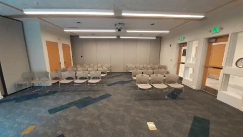 Image of the community room viewed from the front wall, with chairs arranged auditorium-style.