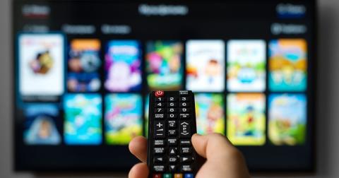 a remote control being pointed at a smart TV