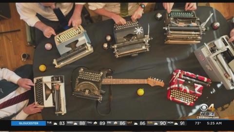 Members of the Boston Typewriter Orchestra play their typewriters as seen from above.