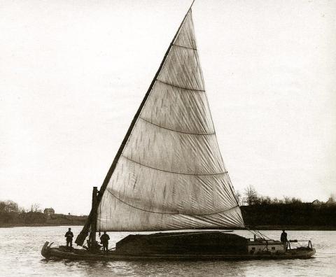 A gundalow on a river from the 1880s