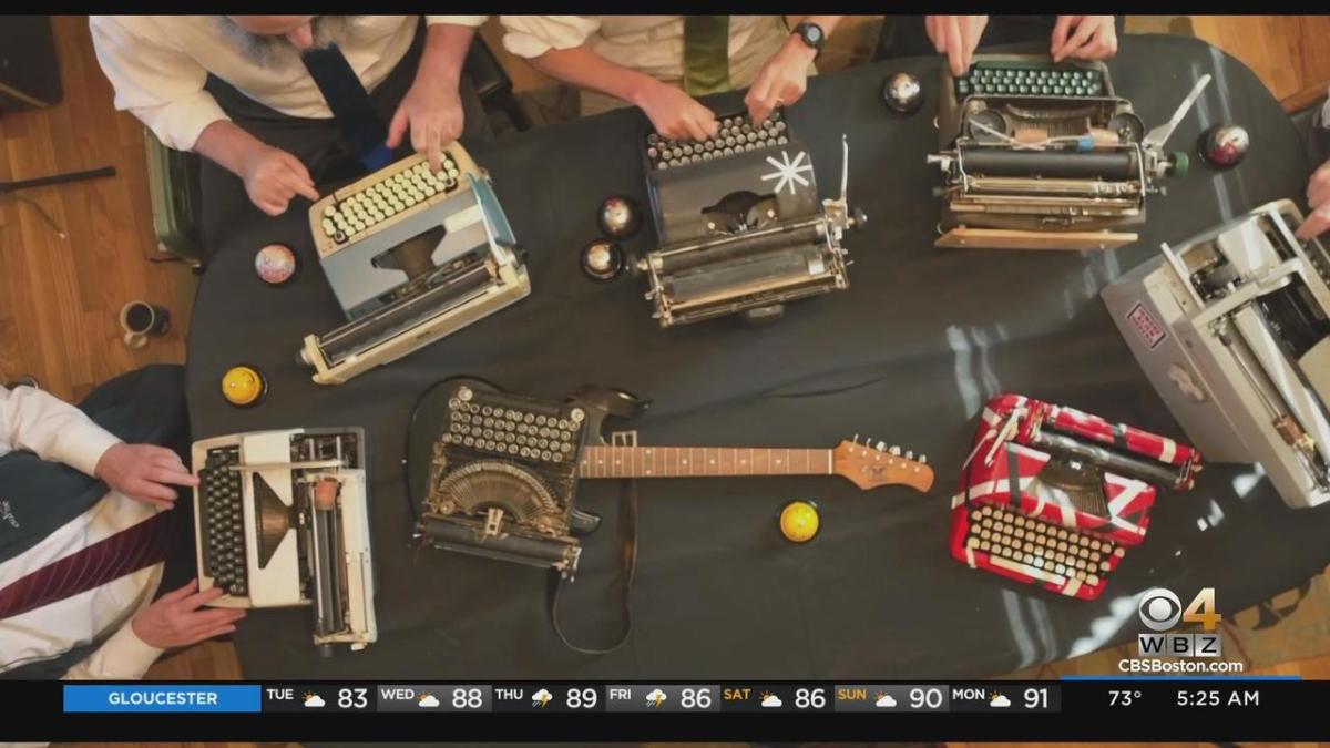 Members of the Boston Typewriter Orchestra play their typewriters as seen from above.